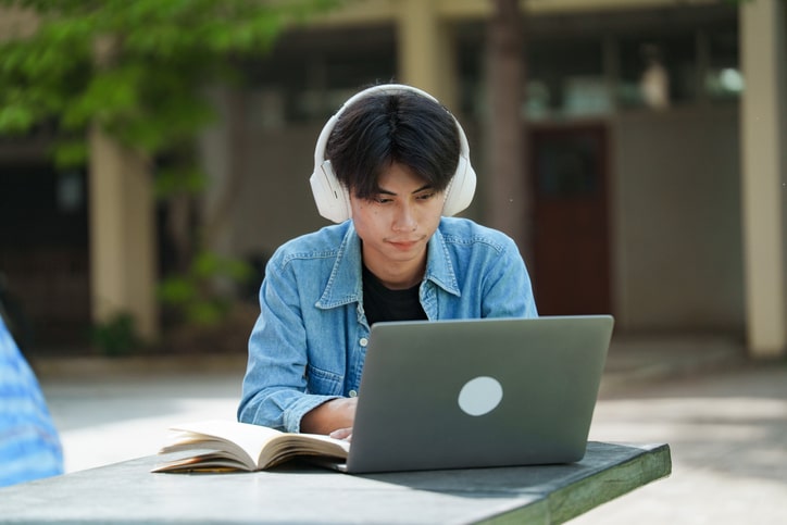 Young college student studying and using laundry service for students